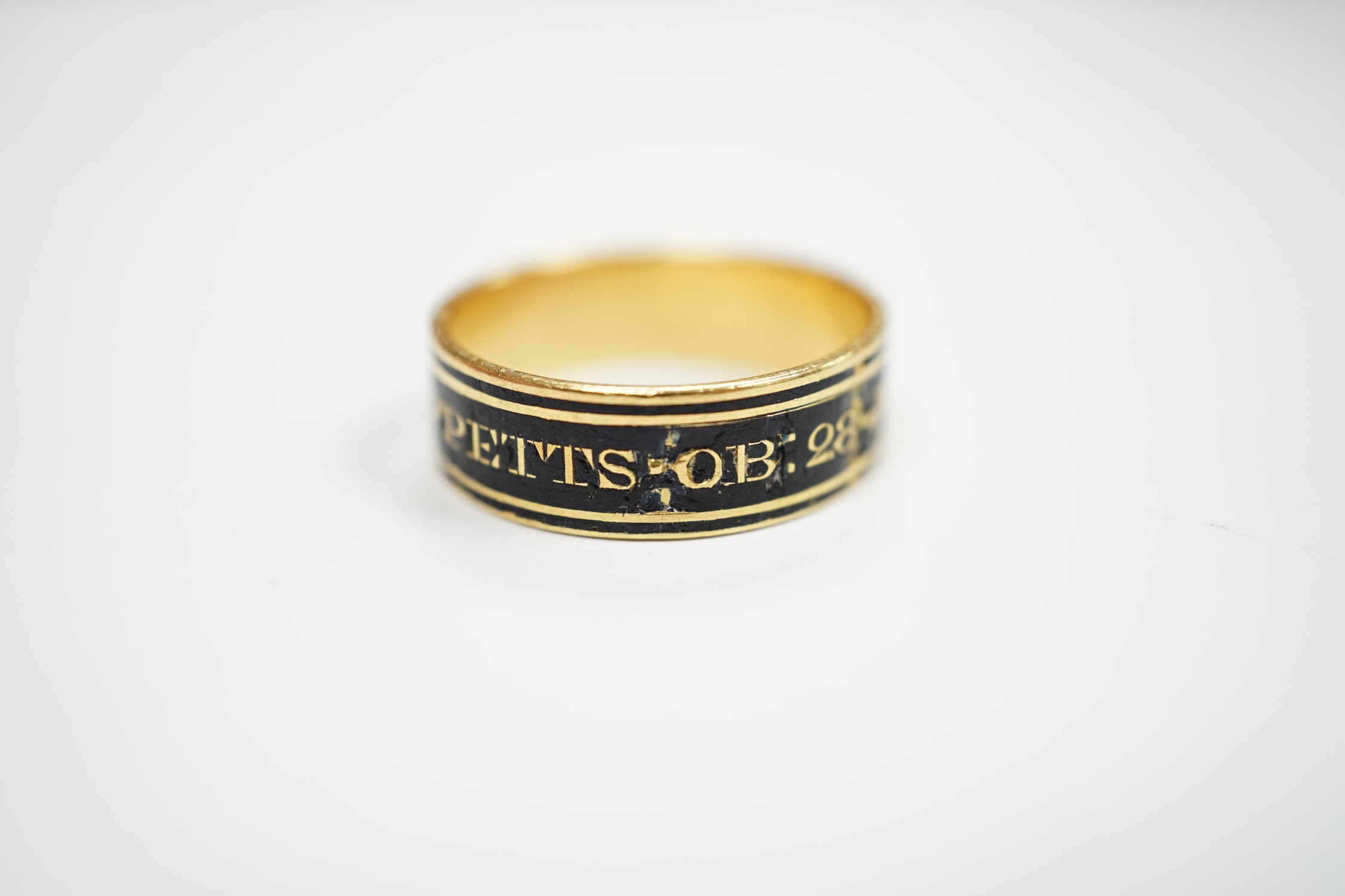 A George III yellow metal and black enamel set mourning band, inscribed ' J.B. Tippetts ob.28 June, 1782, ae.52', size P, gross weight 4.9 grams.